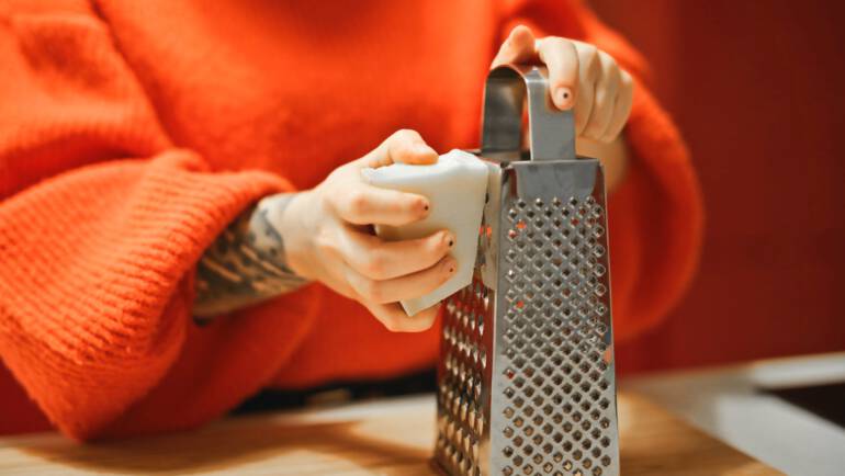 person holding grater
