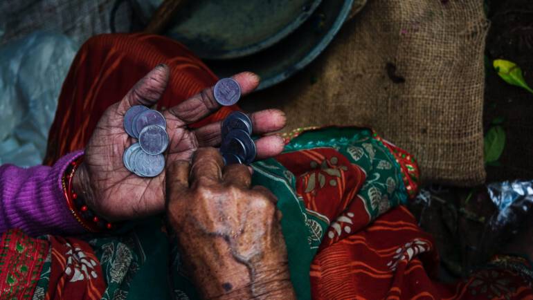 person holding coins