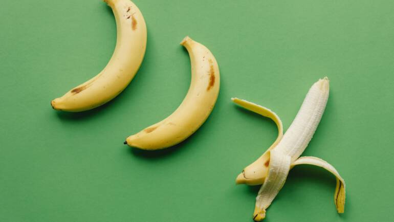 ripe bananas on green surface